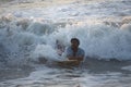 Kovalam, Chennai, Tamilnadu, India - Ã¢â¬Å½Ã¢â¬Å½August 9th Ã¢â¬Å½2021: Young boy Indian surfer surfing and practicing on the beach waves